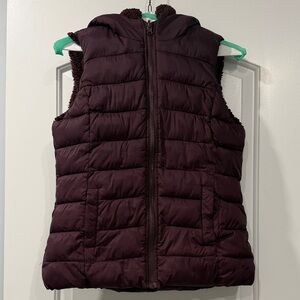 NY & Co Women’s Hooded Puffer Vest in Deep Plum with Sherpa Lining.